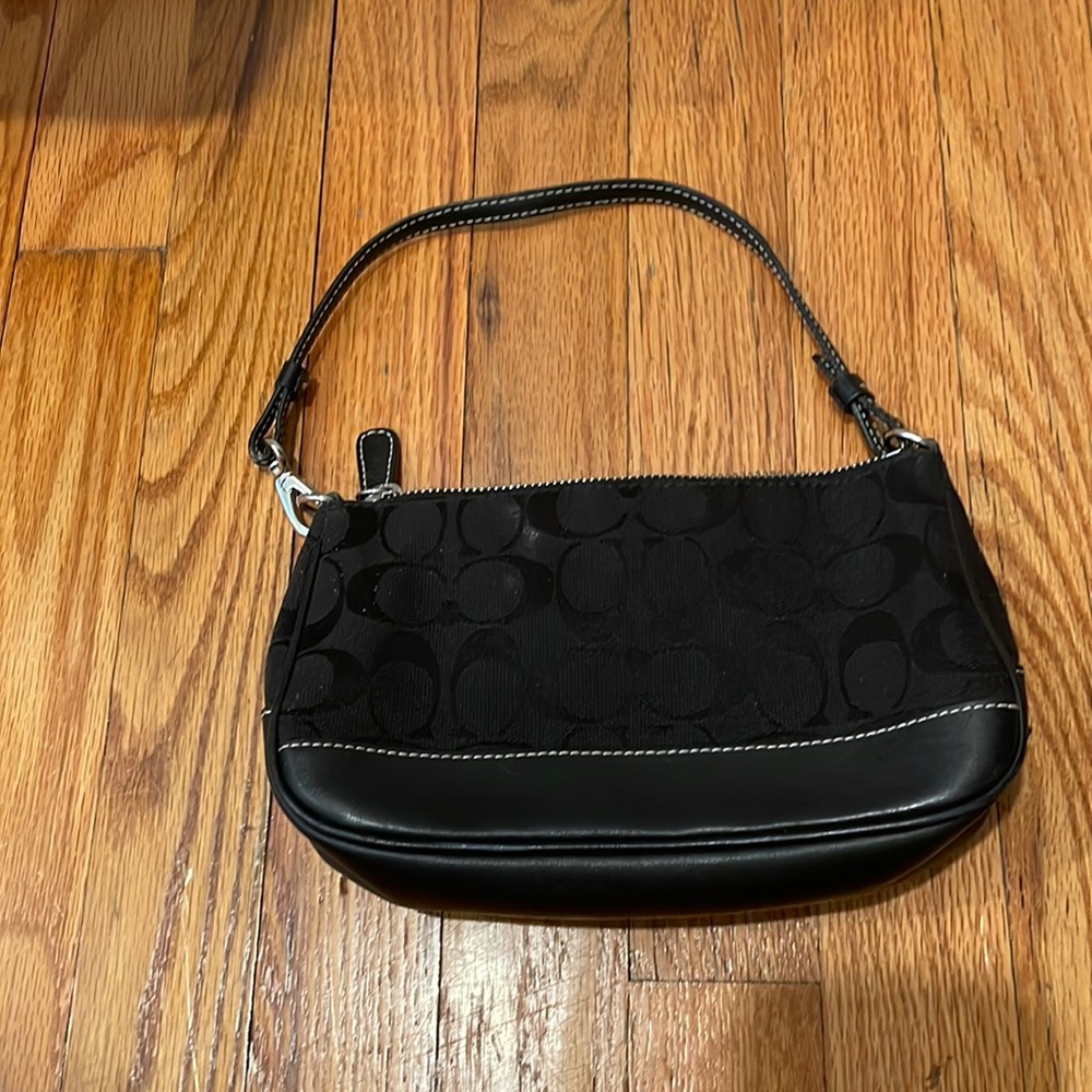 This is a Coach mini bag in the color black and OS fits all!
